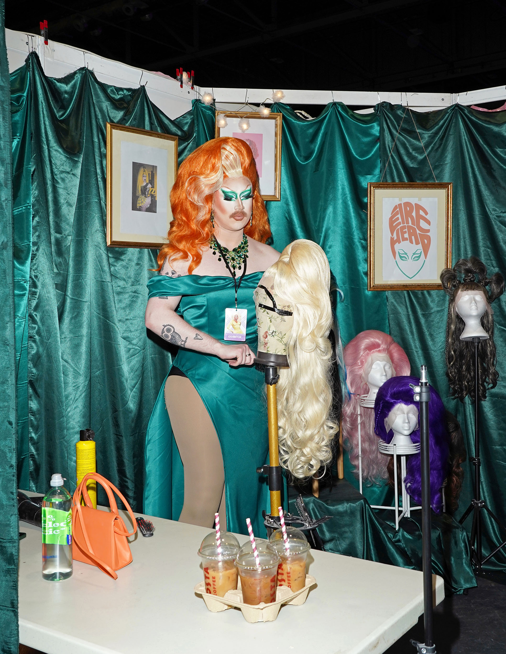 A drag queen prepares a wig in one of the events’ vendor booths