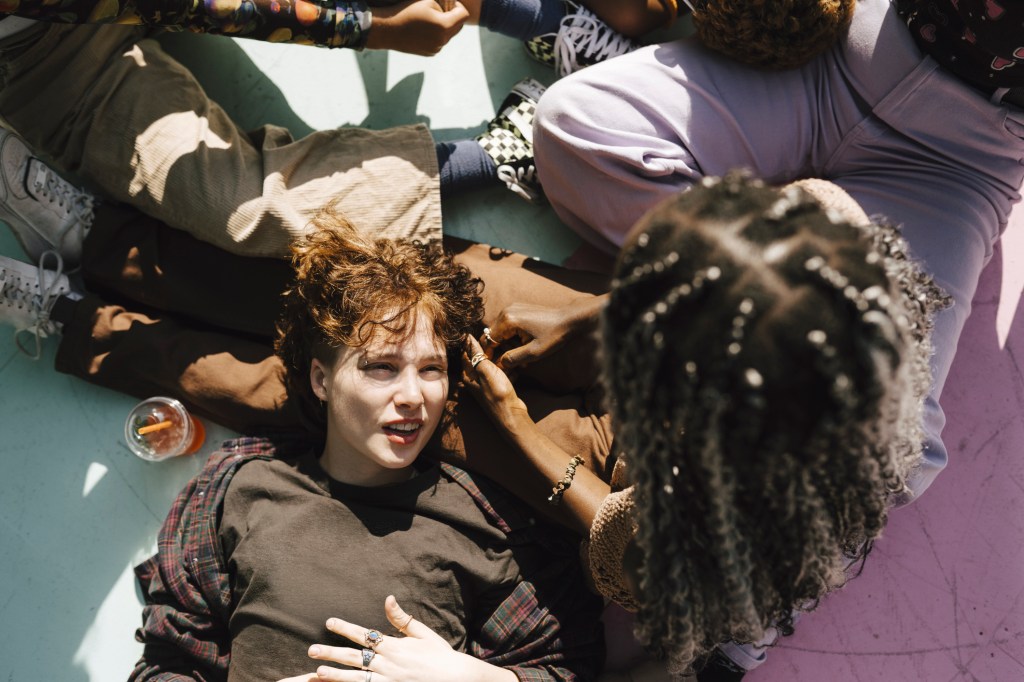 A young person lying on someone's lap and telling a white lie