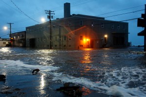 Water rushes down a street in Nome, Alaska, on Saturday, Sept. 17, 2022 as the remnants of Typhoon Merbok moved into the region.​ (AP Photo/Peggy Fagerstrom via The Canadian Press)