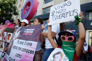 A woman holds the message "We want to be alive" during a silent march to remember murdered women and demand justice for them in Mexico City, Sunday, Sept. 8, 2019.