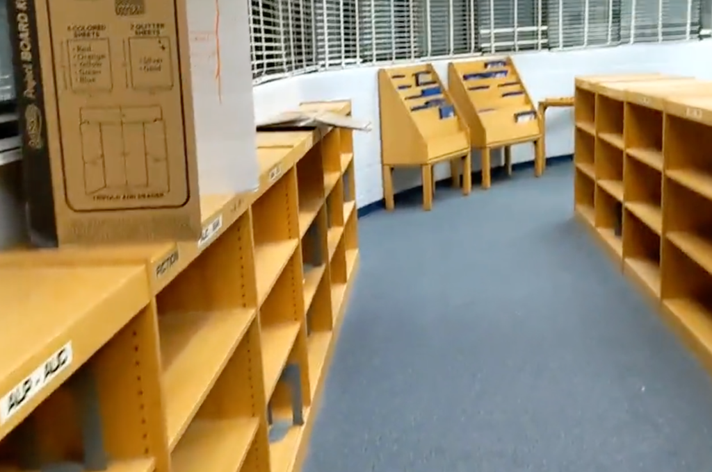 Rows of empty library shelves in a Florida school library