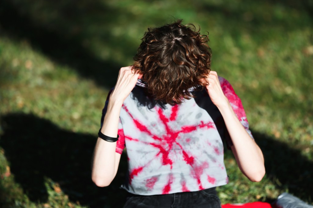 Young woman hiding her face.