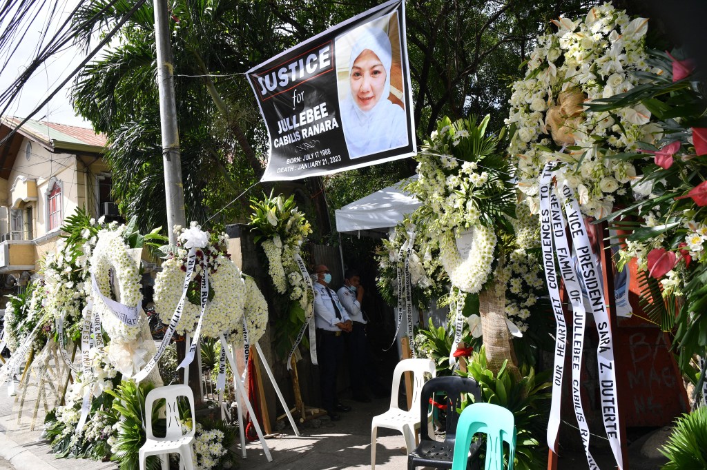 Condolence wreaths are seen outside the residence of Jullebee Ranara, Ranara, a domestic helper who was killed in Kuwait last week, in Las Pinas City, suburban Manila on Jan. 31. Police recovered Ranara's burnt remains in the Kuwaiti desert and later arre