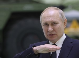 Russian President Vladimir Putin speaks during his meeting with workers at the Obukhov State Plant as a military vehicle seen in the background on January,18,2023, in Saint Petersburg, Russia.