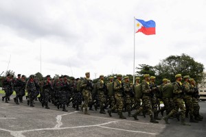 Philippine military personnel march at the military headquarters in Quezon City, suburban Manila. After a soldier opened fire at an army camp in southern Philippines and killed four of his colleagues, experts are calling for better mental health screening