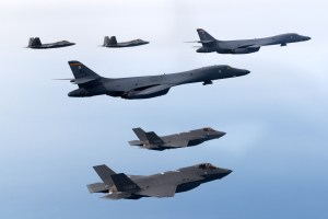 In this handout image released by the South Korean Defense Ministry, U.S. Air Force B-1B bombers (C), F-22 fighter jets and South Korean Air Force F-35 fighter jets (bottom) fly over South Korea Peninsula during a joint air drill on February 01, 2023 at a