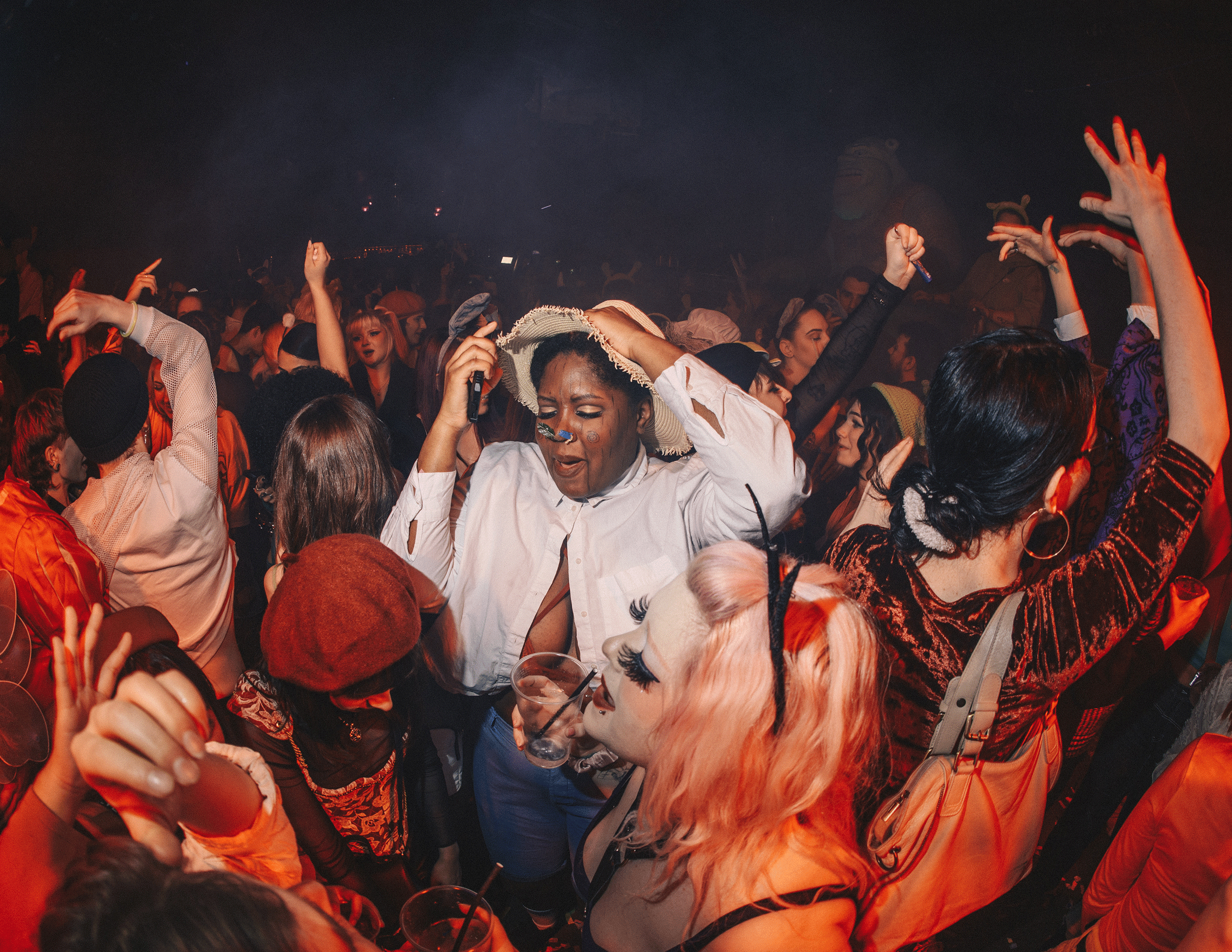 Shrek Rave, London: Clubbers dancing around someone dressed as Scarecrow