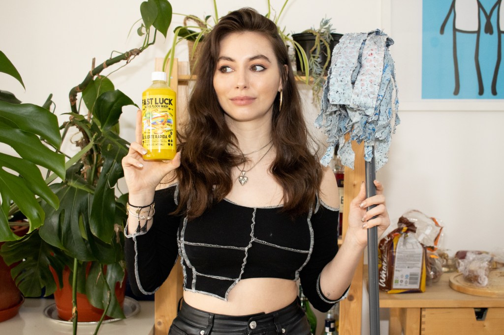 A woman holding up fast luck soap and lucky floorwash