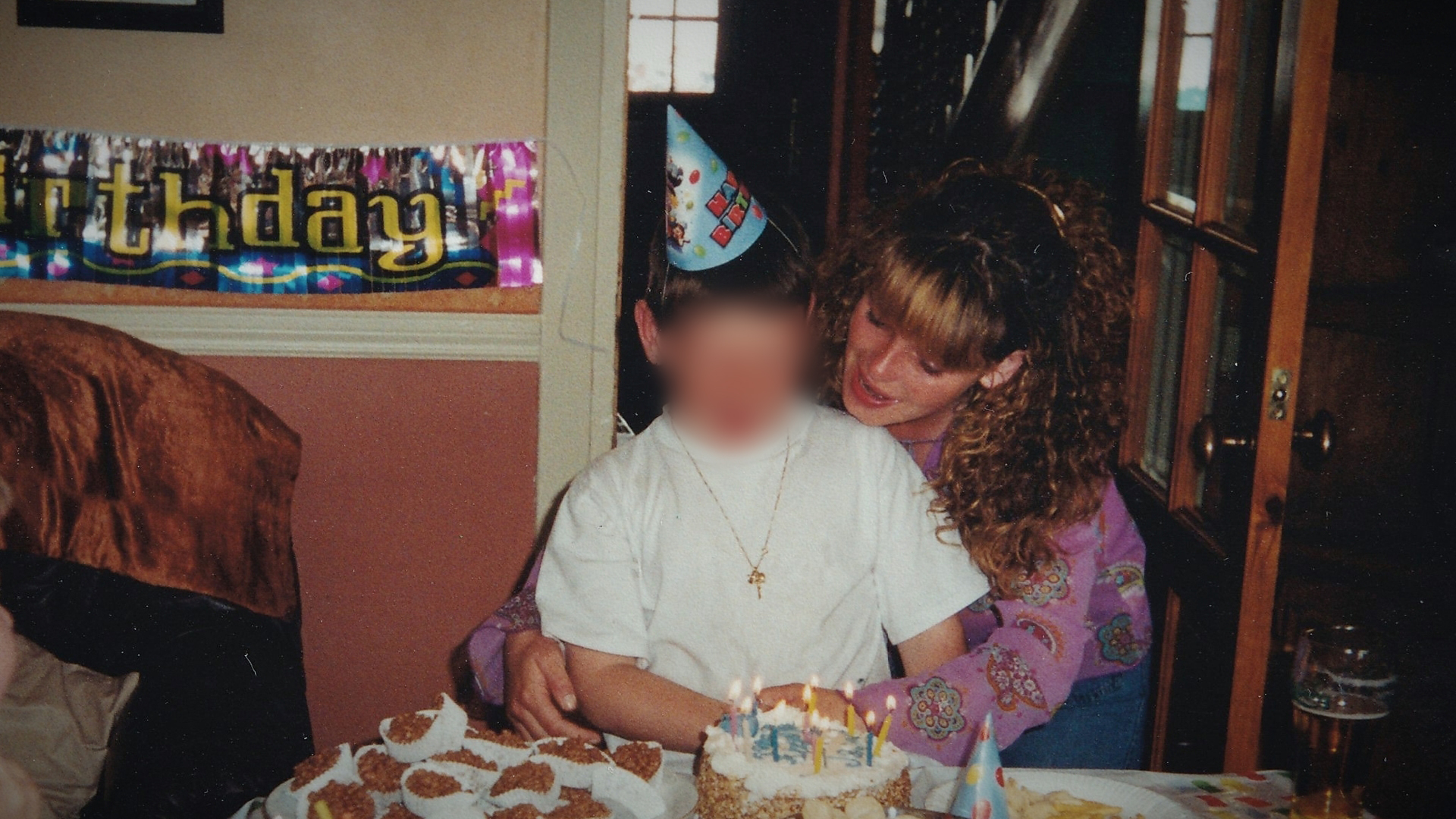 A photo of jessica helping her son cut his birthday cake.