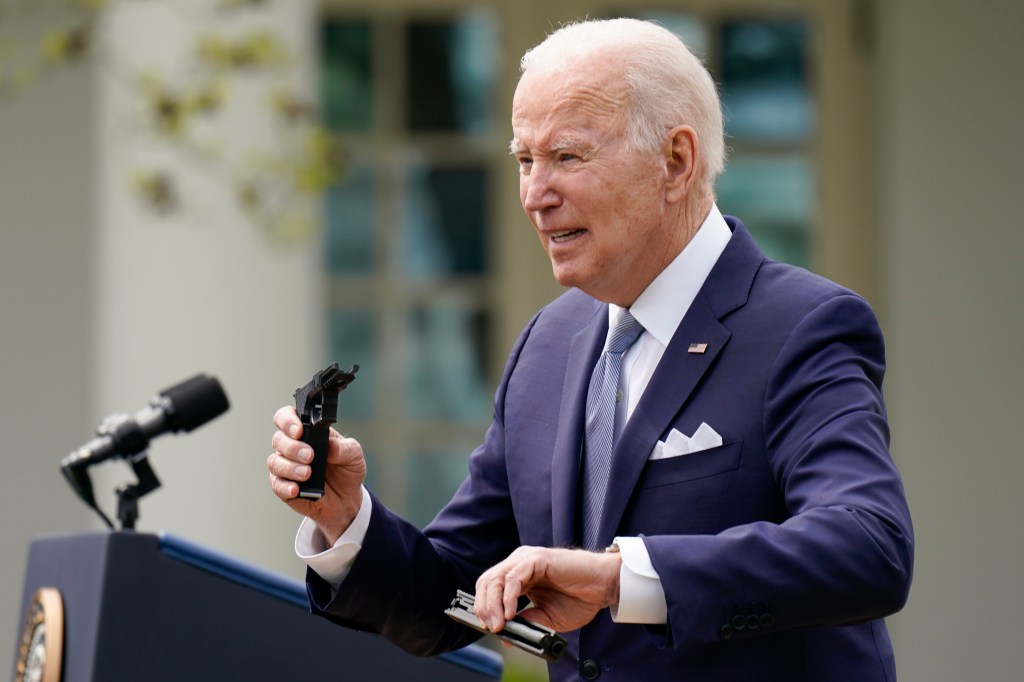 President Joe Biden holds pieces of a 9mm pistol as he speaks in the Rose Garden of the White House in Washington, Monday, April 11, 2022.