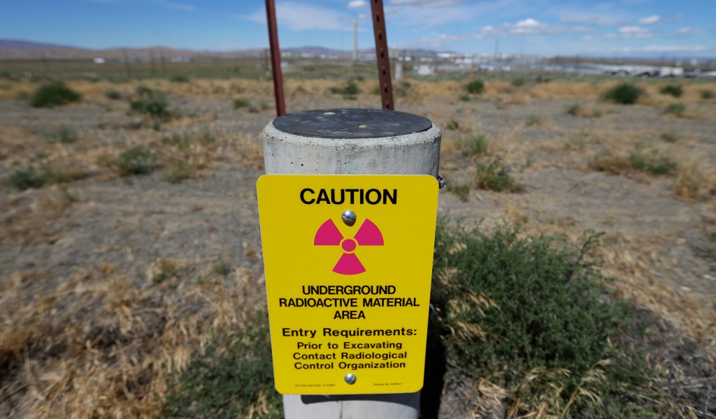 a sign warns of radioactive material stored underground on the Hanford Nuclear Reservation near Richland.