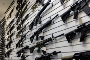 A selection of AR-15-style rifles hangs on a wall at R-Guns store on Jan. 11, 2023, in Carpentersville, Illinois, a day after the state ban.