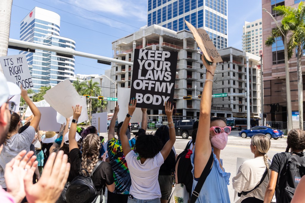 An abortion rights activist holds a sign at a protest in support of abortion access on July 13, 2022 in Fort Lauderdale, Florida. (Photo by John Parra / Getty Images)