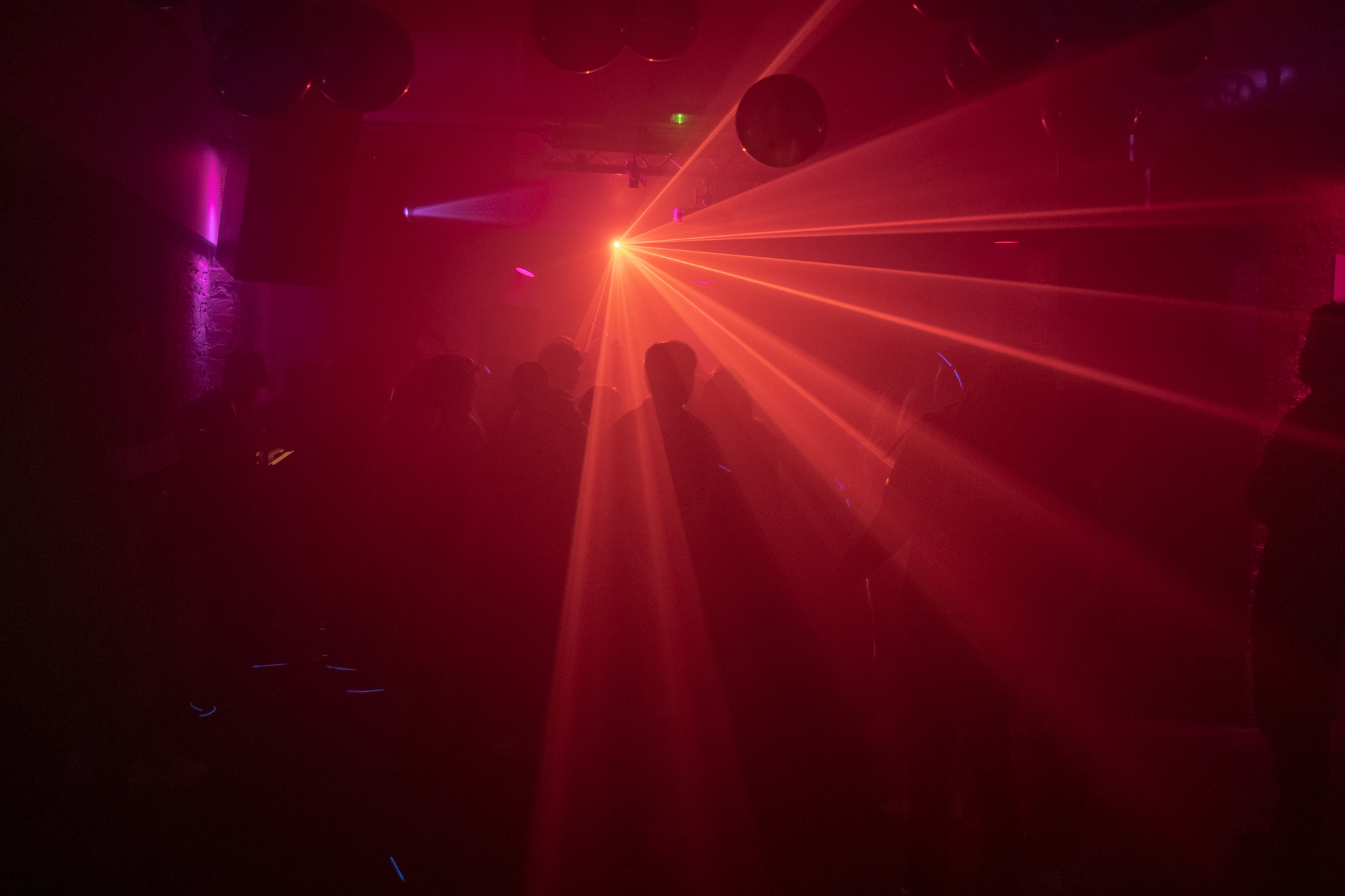 People on a dancefloor with red strobes