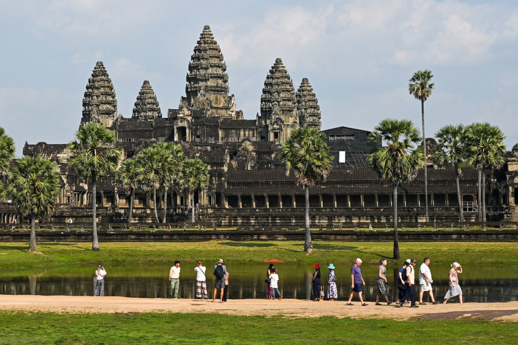 The Angkor Archaeological Park houses an estimated 100,000 people, many of whom have lived there for generations and rly on the tourism industry. TANG CHHIN SOTHY / AFP