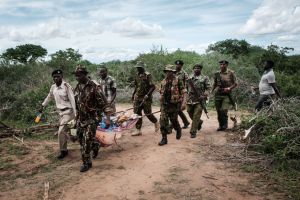 Security personnel carry a rescued young person from the forest in Shakahola, outside the coastal town of Malindi, on April 23, 2023