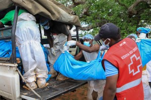 Police and local residents load the exhumed bodies of victims of a religious cult into the back of a truck in the village of Shakahola, near the coastal city of Malindi, in southern Kenya Sunday, April 23, 2023.