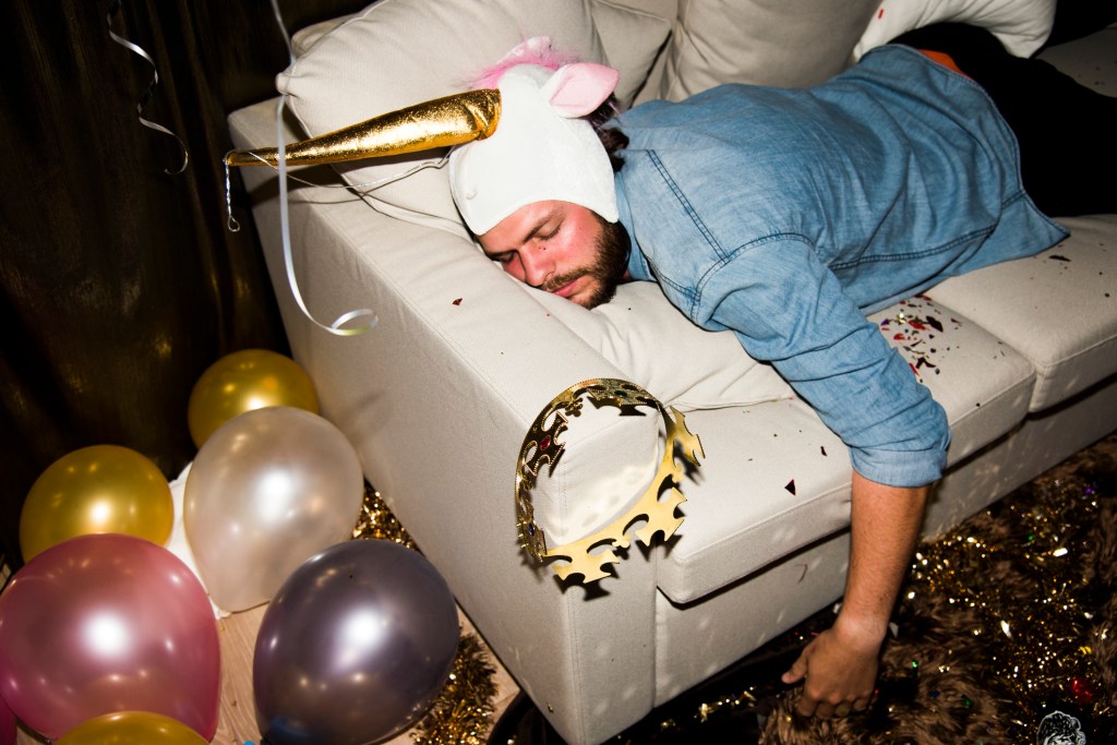 Man passed out on a white couch