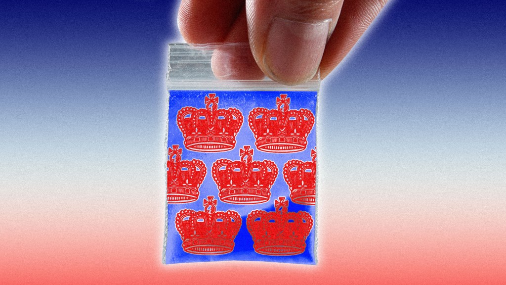 Hand holding a King Charles crown-themed baggie of drugs