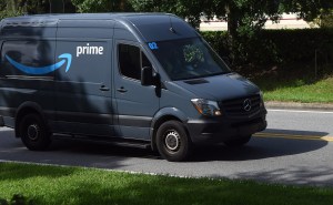 amazon prime delivery van drives on street