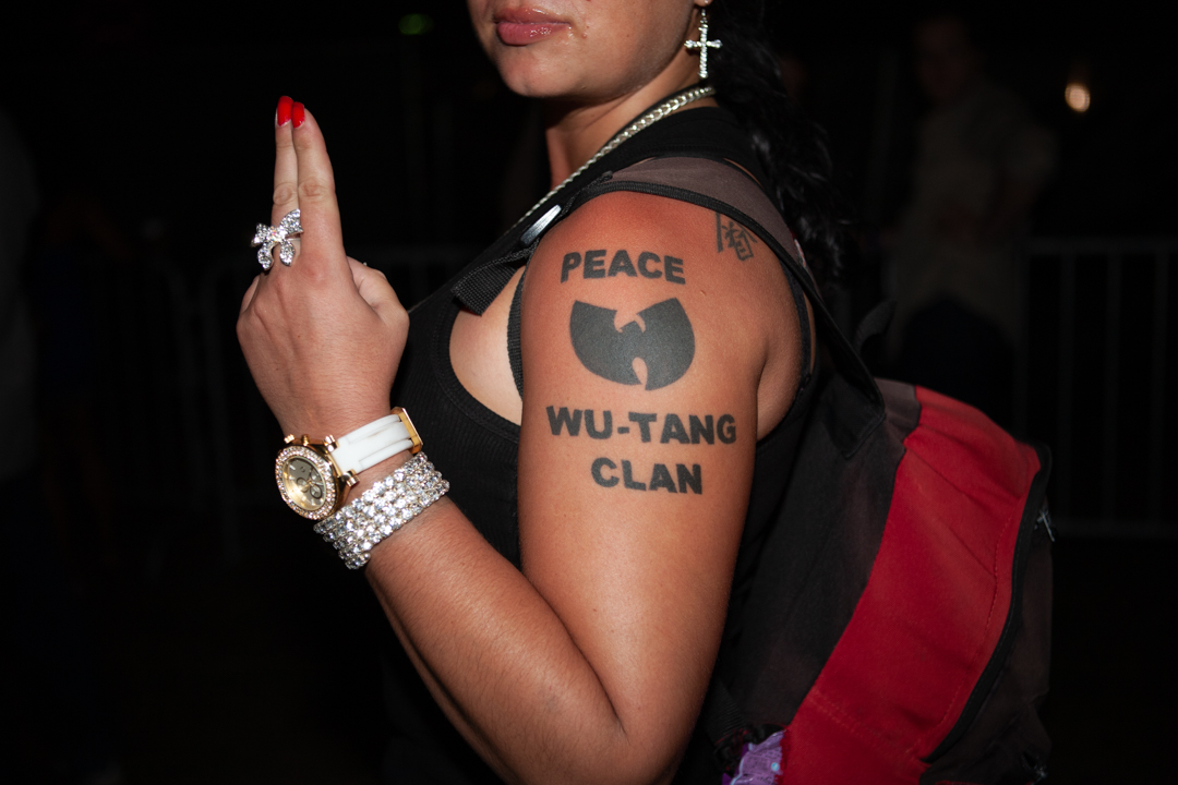 A woman with a Wu Tang Clan tattoo and blingy jewellery at Rock the Bells on Governors Island, NY, 2010.