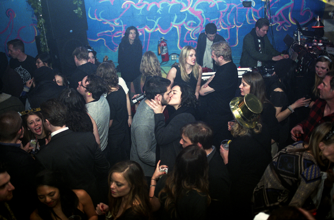 A couple kiss on a crowded dancefloor at Glasslands club in Williamsburg, Brooklyn, 2014.