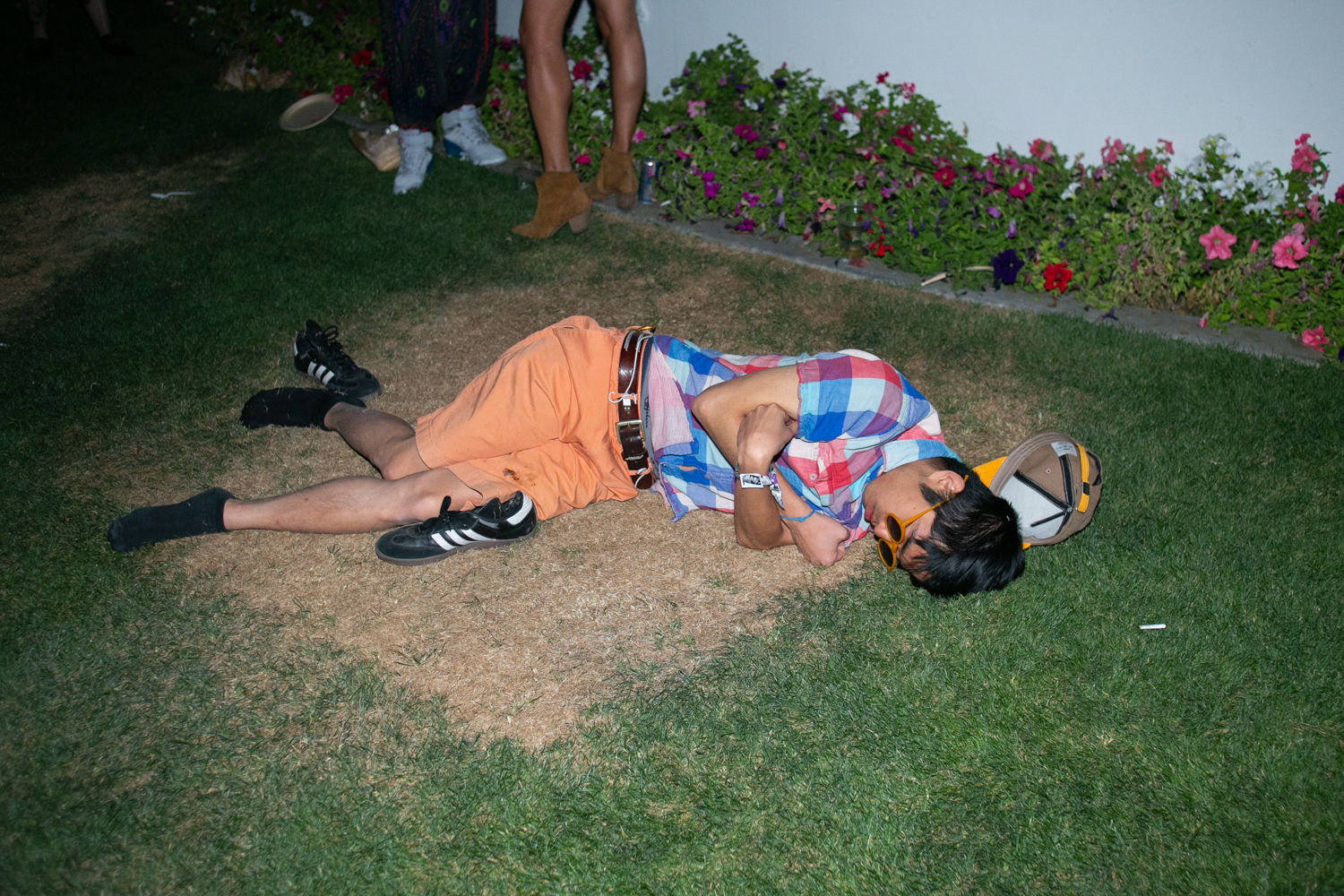 A man passed out on green grass