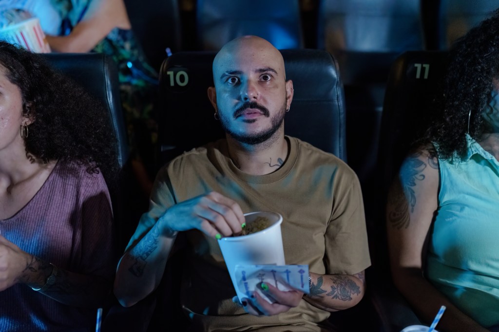 man watching a film in a cinema