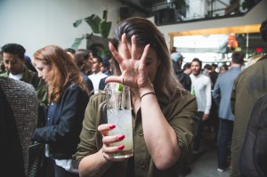 A woman holding a cocktail