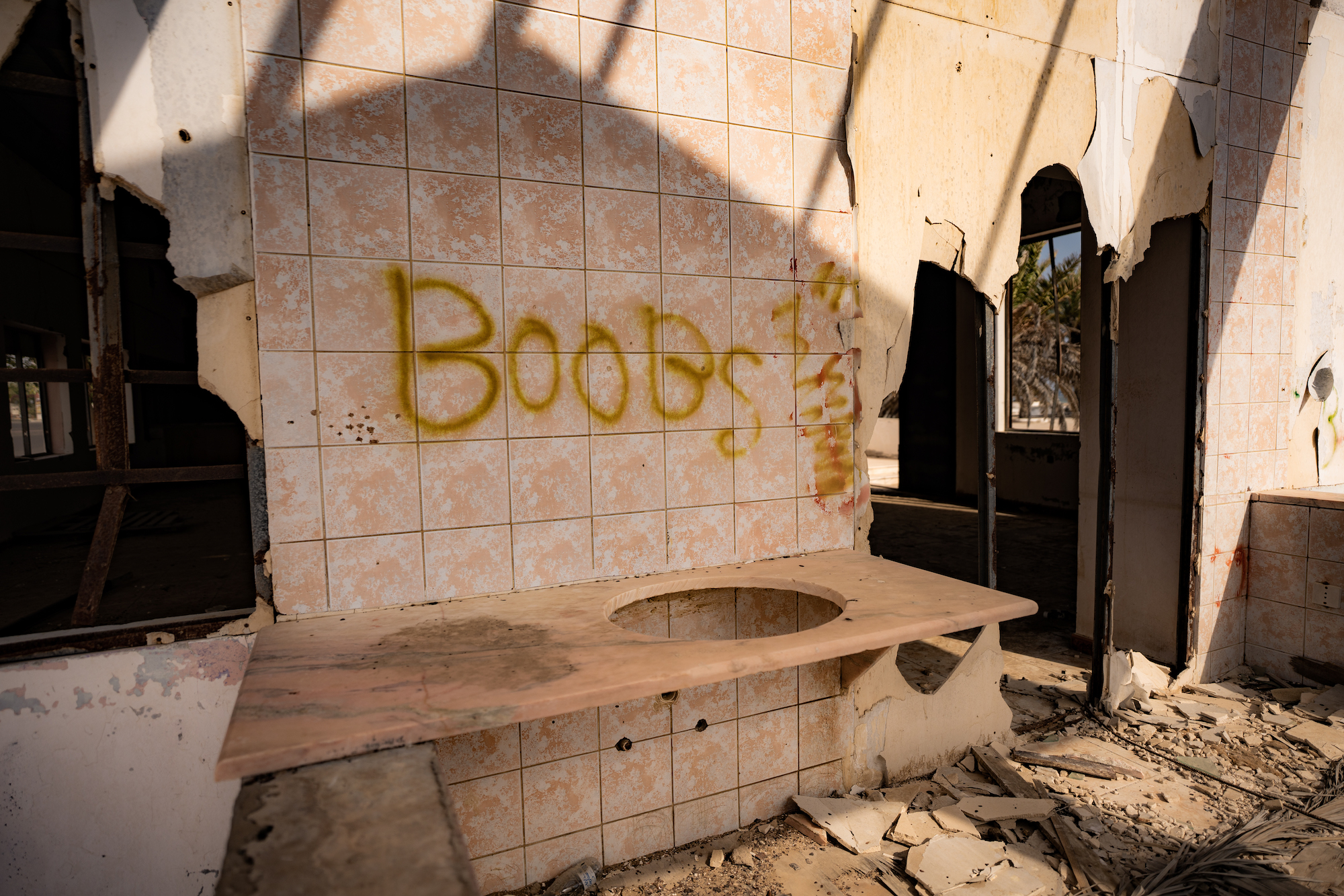 Graffiti reading boobs on a tiled wall