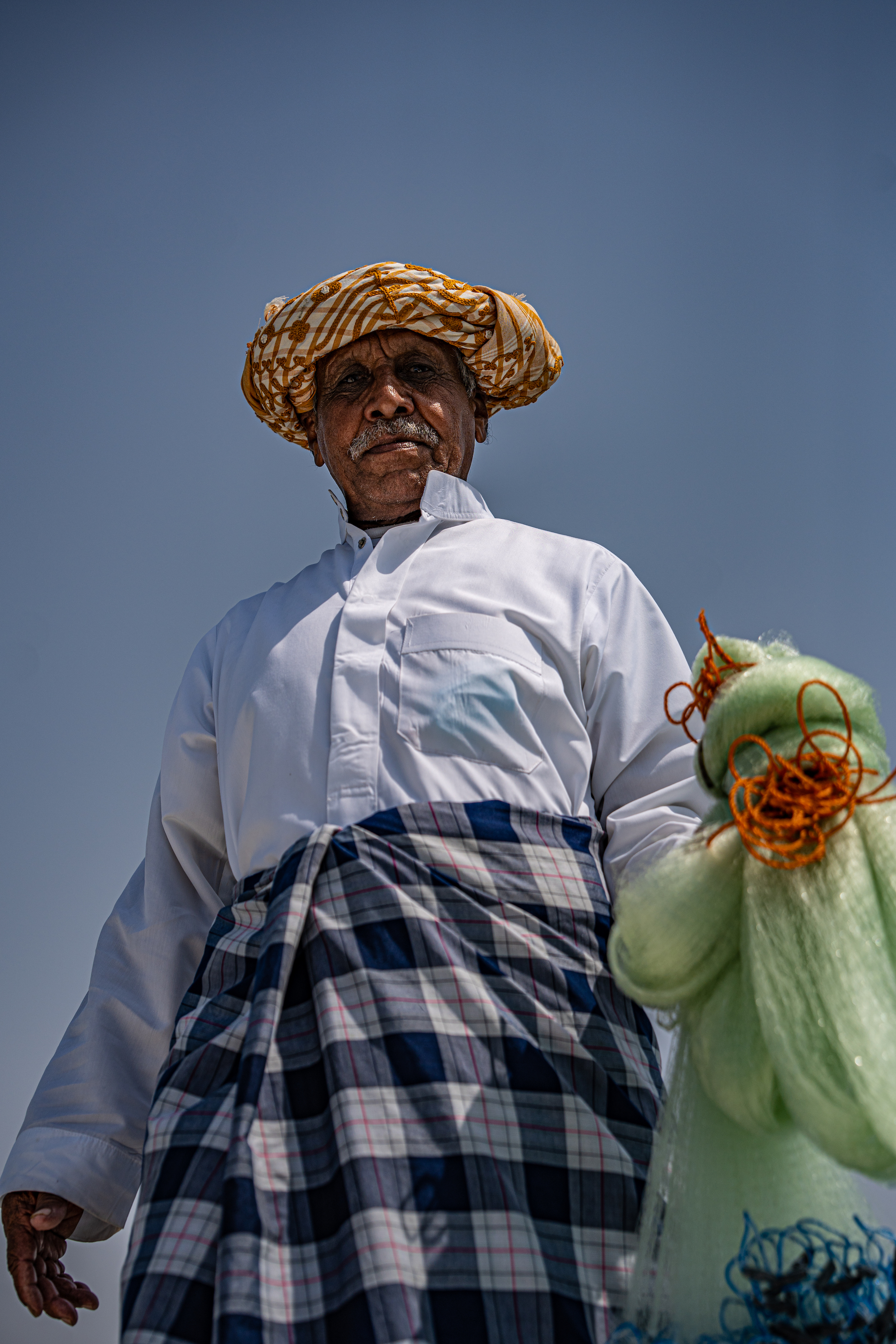 An old fisherman in a shirt