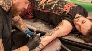 Man getting tattoo at Download Festival