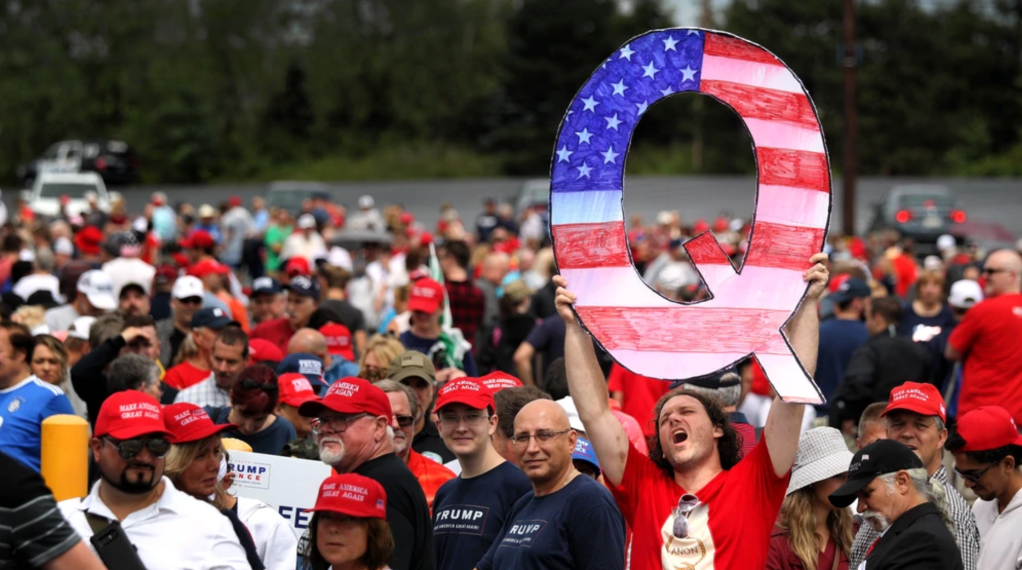 A SUPPORTER HOLDS UP A LARGE "Q" SIGN WHILE WAITING IN LINE TO SEE NOW FORMER PRESIDENT DONALD TRUMP AT HIS RALLY ON AUGUST 2, 2018  IN WILKES BARRE, PENNSYLVANIA.