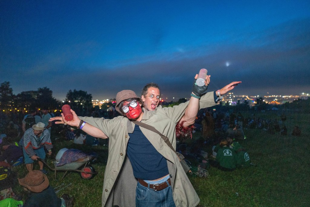 Writer Snake Denton with his arms outstretched at Glastonbury