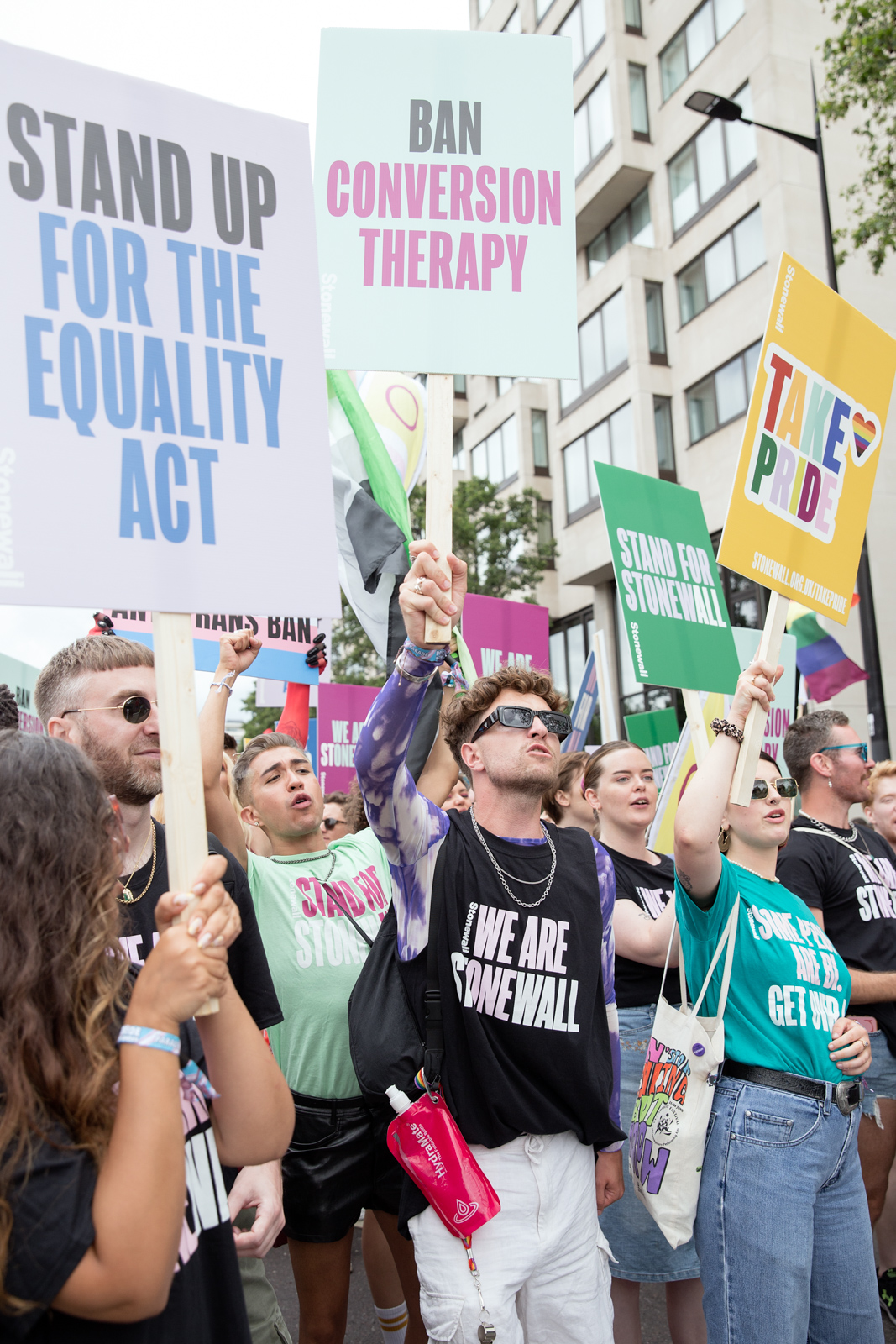 London Pride 2023: Marchers holding up protest signs