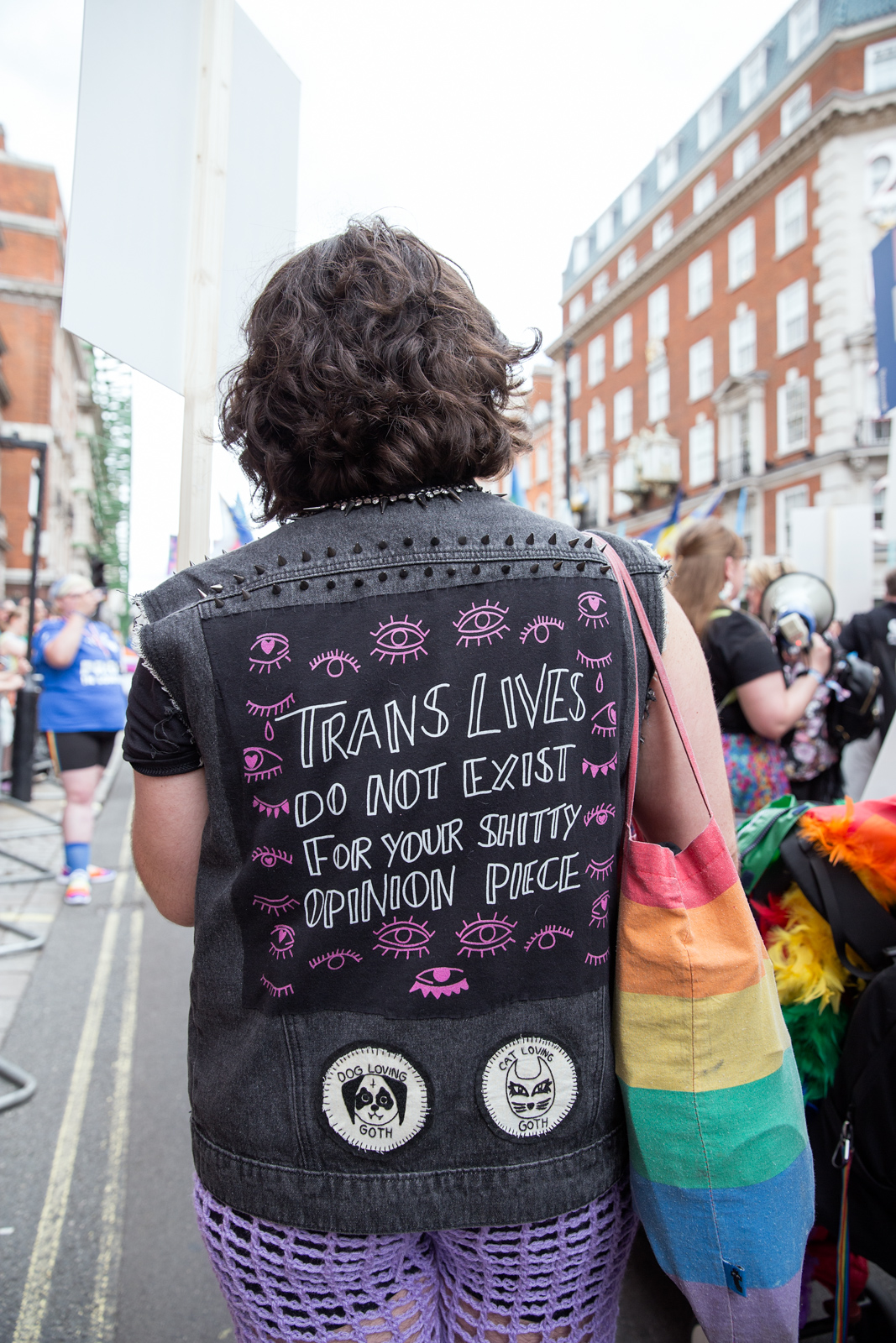 London Pride 2023: Person with denim jacket reading Trans People Do Not Exist For Your Shitty Opinion Piece