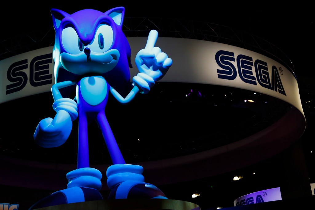 sonic the hedgehog in front of sega sign