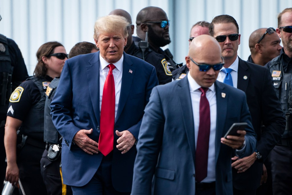 Former President Donald Trump and his aid Walt Nauta (right) arrive at an airport after Trump spoke at the Georgia Republican Party's state convention on Saturday, June 10, 2023 in Columbus, GA.