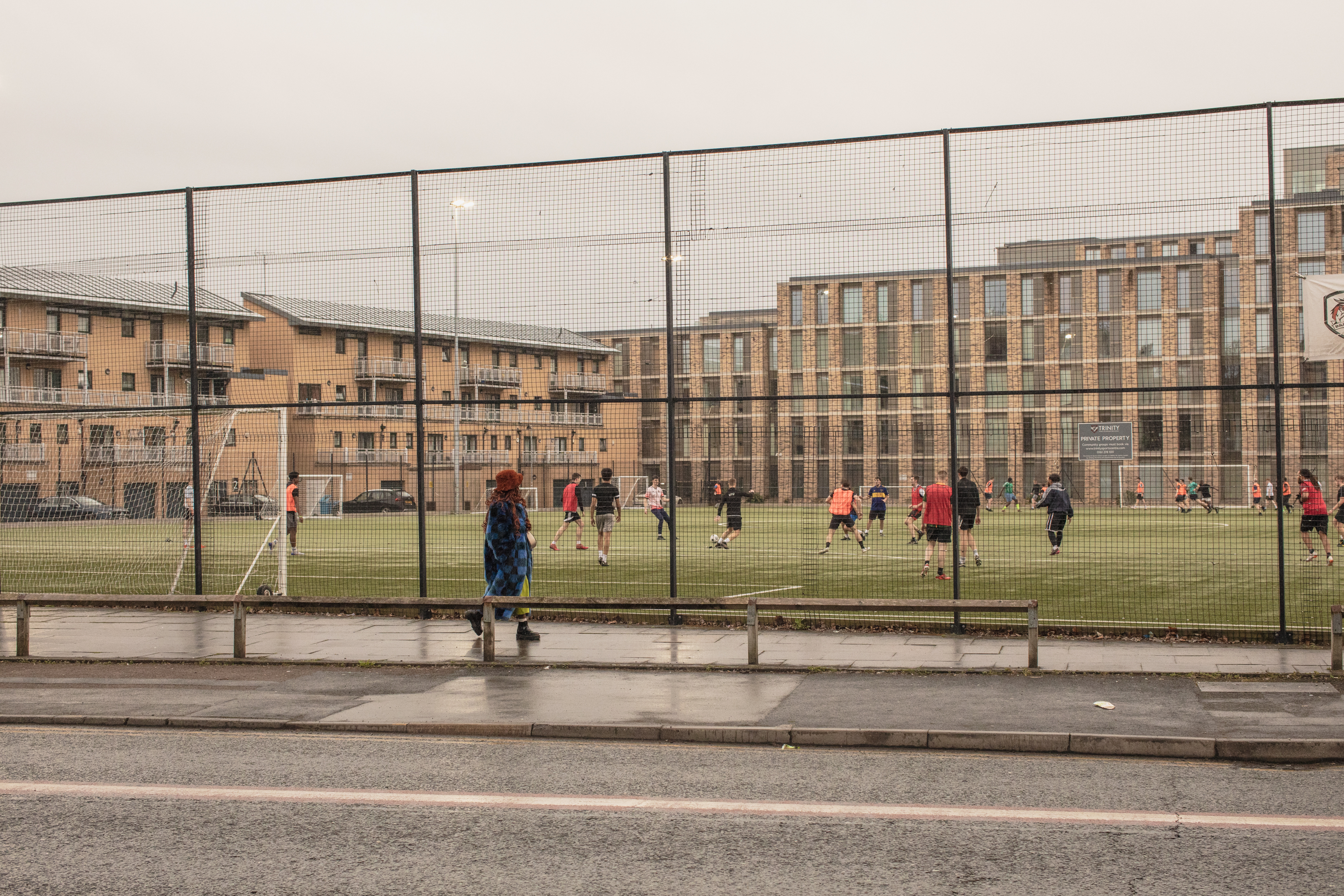 Manchester, UK: Kemi Alemoru walks alongside Moss Side football pitch