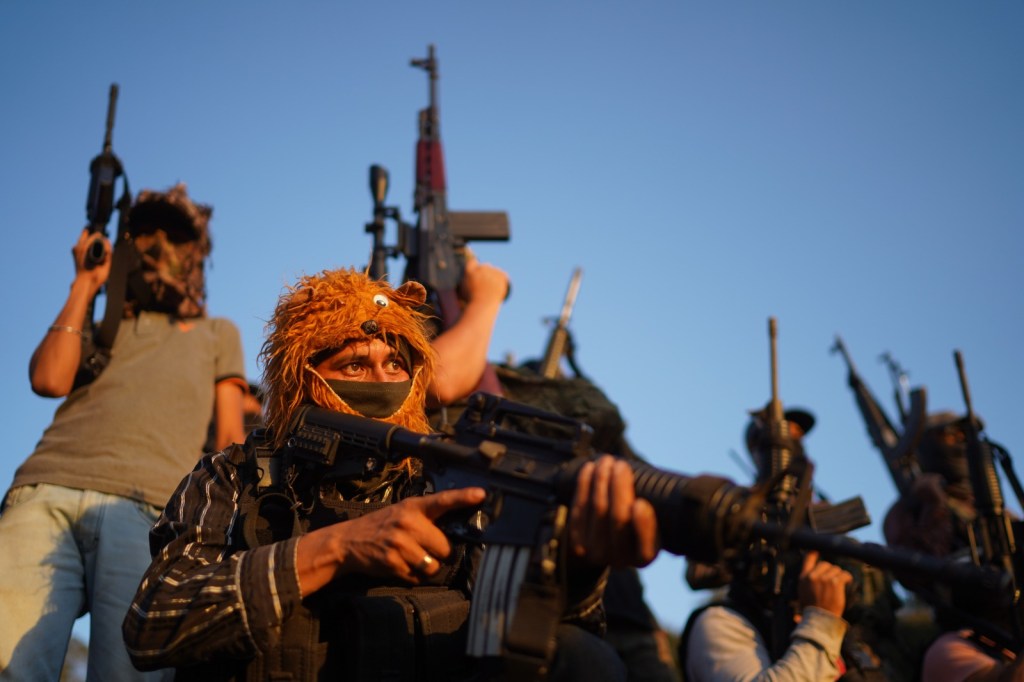 Members of a self-defense group in Michoacán get ready to go on patrol in Tepalcatepec, Michoacán in June 2023.