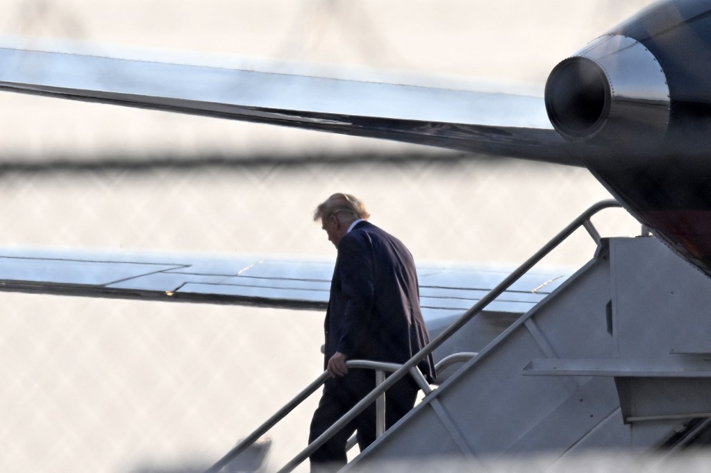 Former US President Donald Trump steps off his plane Trump Force One upon arrival at Atlanta Hartsfield-Jackson International Airport on his way to the Fulton County Jail in Atlanta, Georgia, on August 24, 2023. (ANDREW CABALLERO-REYNOLDS/AFP via Getty Im