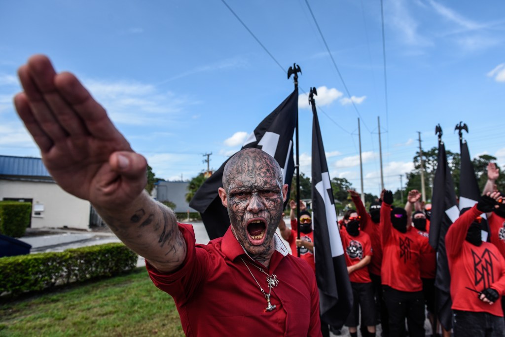 Kent "Boneface" McLellan does a Nazi salute as two Neo Nazi groups, Blood Tribe and Goyim Defense League, hold a rally on September 2, 2023 in Orlando, Florida.