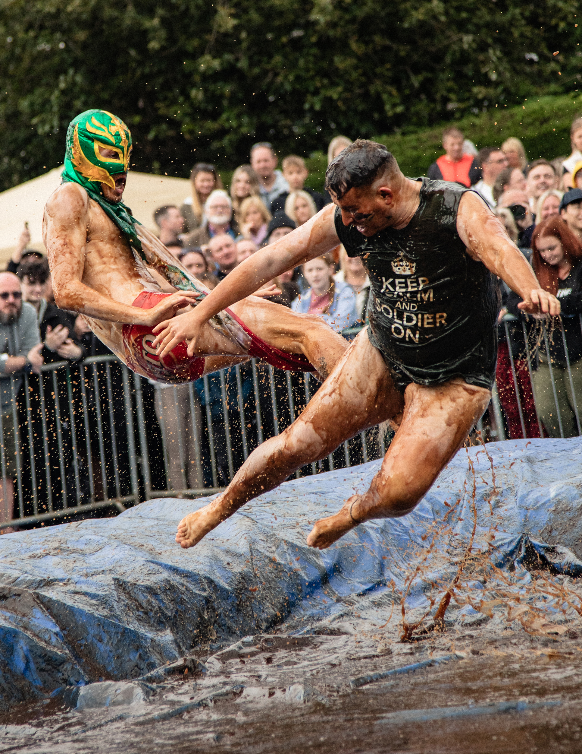 world gravy championships - a photo of two men wrestling in a gravy filled wrestling ring.