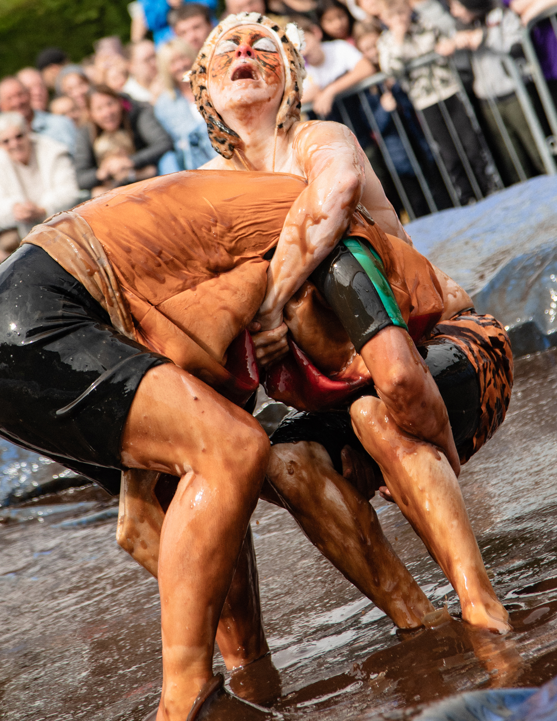 world gravy championships - a photo of two people wrestling in a gravy filled wrestling ring.