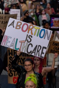 Person holding pro abortion sign at a protest