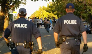 Police facing crowd, backs to camera