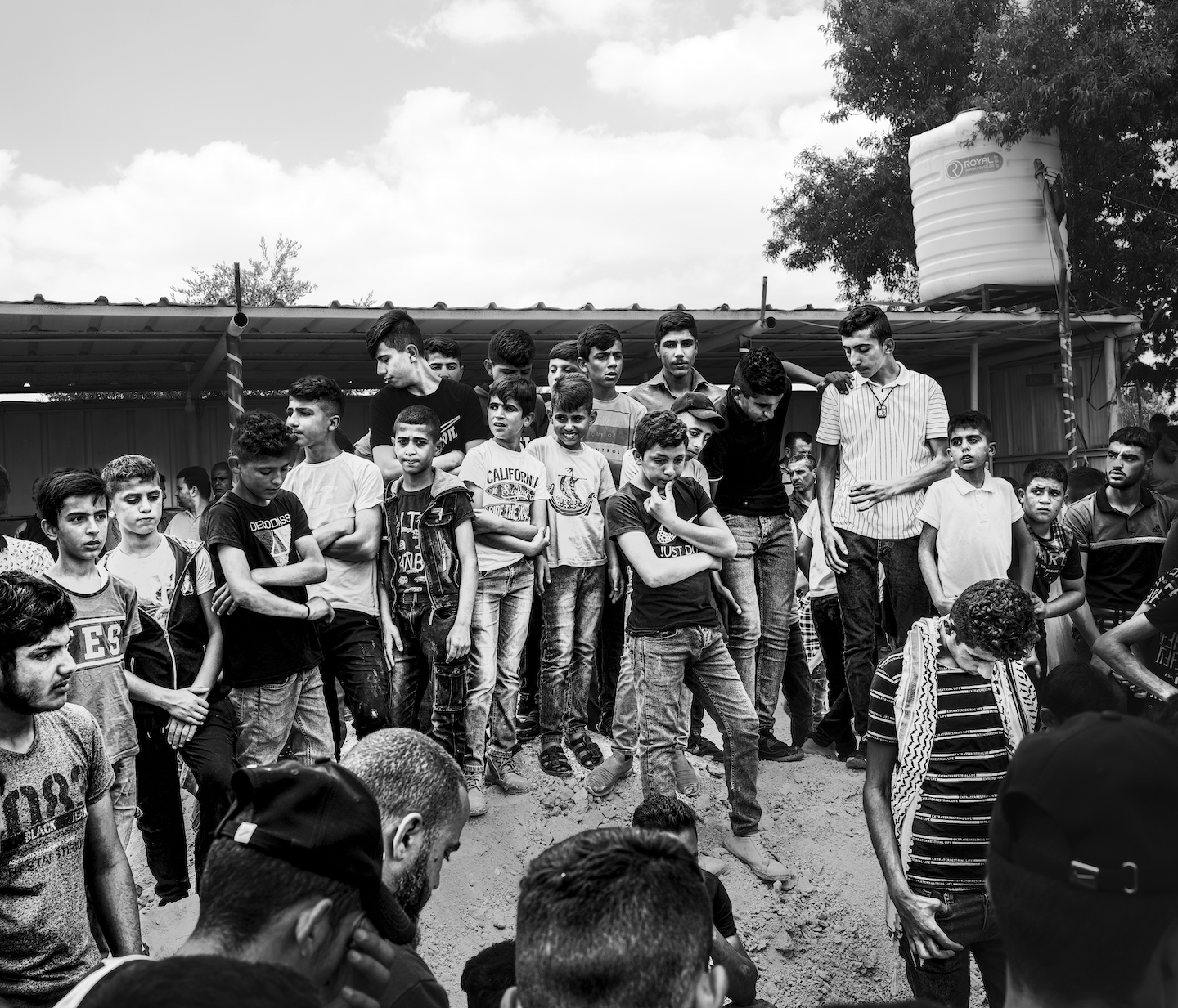 A group of children and teens standing around.