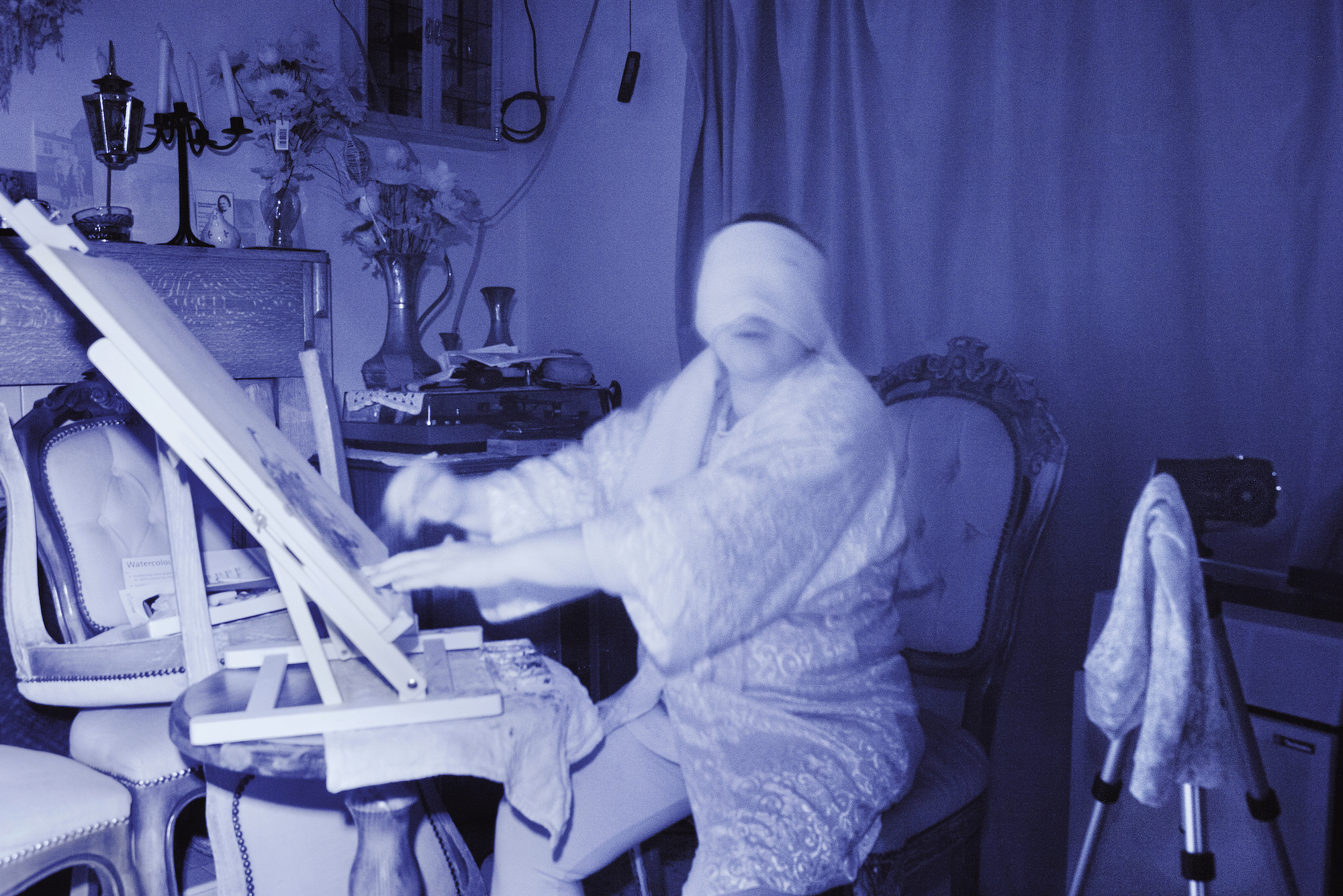 Medium Sylvia Howarth conducts a trance spirit art demonstration in her home. England, 2013.