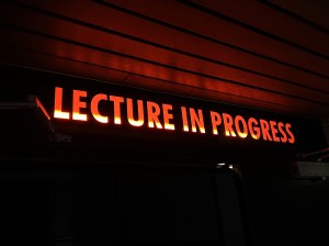 ​A light-up sign outside of a university lecture