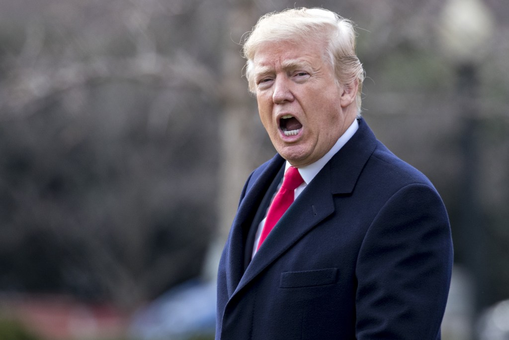 U.S. President Donald Trump yells to members of the media before boarding Marine One on the South Lawn of the White House in Washington, D.C., U.S., on Friday, Dec. 22, 2017.